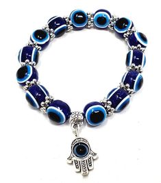 This 8 mm Elastic Bracelet is a stylish and versatile accessory. Featuring Evil Eye Beads and a Hamsa Hand Charm, it offers a unique look that is perfect for everyday wear. The elastic design allows it to stretch and fit comfortably on any wrist size. Add a touch of protection and fashion to your wardrobe with this must-have bracelet. Symbolic Adjustable Stretch Bracelet With Round Beads, Casual Evil Eye Bracelet With Round Beads, Casual Evil Eye Round Beads Bracelets, Adjustable Evil Eye Charm Bracelet, Symbolic Beaded Bracelets With 8mm Beads, Adjustable Evil Eye Bracelet With 8mm Beads, Dream Items, Evil Eye Beads, Candle Carving