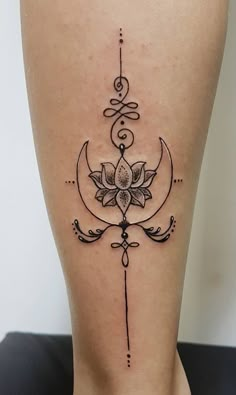 a woman's lower leg with a flower and crescent tattoo on the bottom side