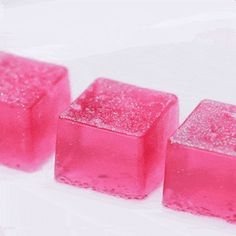 three pink cubes sitting next to each other on top of a white countertop