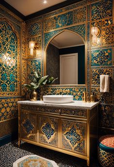 an ornate bathroom with gold and blue decor on the vanity, mirror and rugs