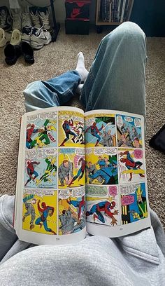 a person laying on the floor reading a comic book