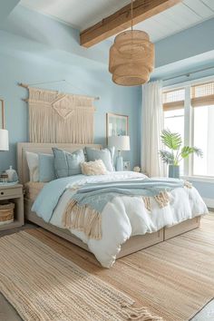 a bedroom with blue walls and white bedding, rugs on the floor and windows