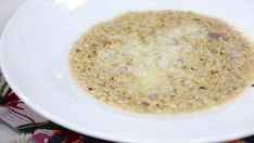 a white bowl filled with food on top of a table