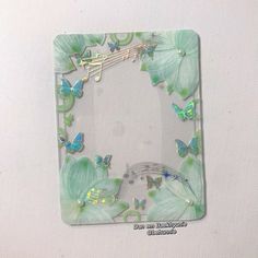 a glass frame decorated with butterflies and music notes