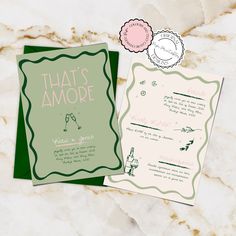 two wedding cards with the words that's amore written in pink and green on them