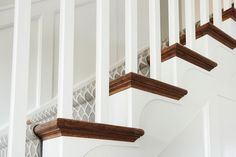 the stair railings are made of wood and white paint