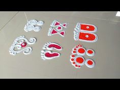 some red and white decorations are on a table with one person's feet in the middle