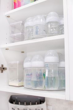 the shelves are filled with baby bottles, containers and other items to keep them organized