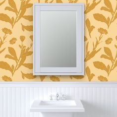 a white sink sitting under a bathroom mirror next to a wall mounted faucet