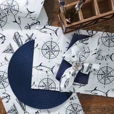 nautical themed placemats and napkins on a wooden table