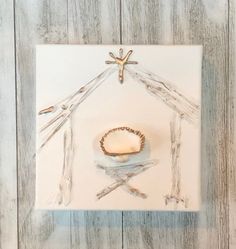 a nativity scene made out of wood and glass on a white background with a cross