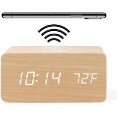 the alarm clock is made from wood and has an iphone on it's side