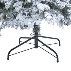 a pine tree with snow on it and a black stand for the top ornament