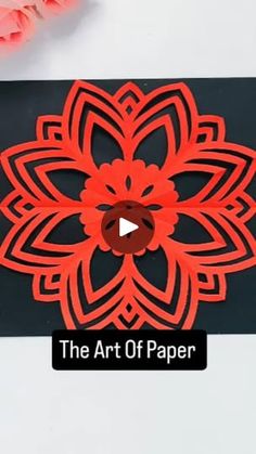 the art of paper is being displayed on a white table with pink flowers and scissors