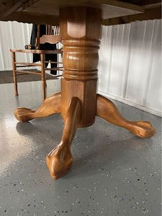 a wooden table with two chairs around it