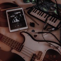 an electronic device sitting on top of a table next to musical instruments