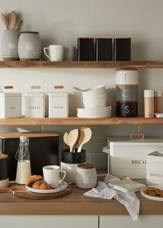 the kitchen counter is stocked with coffee, milk and other breakfast foods including croissants