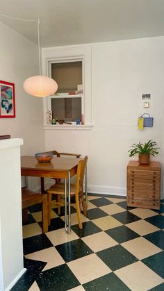 a room with a checkered floor and white walls