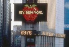 the new york times square sign has an apple on it's back and is lit up