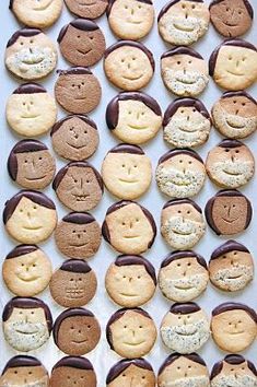 some cookies with faces on them are arranged in the shape of people's heads