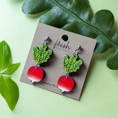 These cute radish earrings are inspired by the "Sparkler" radish or breakfast radish varieties with their distinctive vivid coloring and plump roundness. These original earrings are hand painted on cherry wood with two separate pieces, etched details, and a gorgeous ombre of bright red to white. Lightweight and cute, these radishes are a fun addition to your wardrobe and a great gift for a gardener or fan of Luna Lovegood. Option 1: Silver Ear WiresThese earrings feature silver hypoallergenic 304 stainless steel ear wires. Option 2: Gold Ear WiresThese earrings feature gold hypoallergenic 304 stainless steel ear wiresOption 3: Silver Ball PostsThese earrings feature 4mm silver-plated brass ball posts with butterfly backs.Option 4: Gold Ball PostsThese earrings feature 4mm 24k gold-plated b Luna Lovegood Radish Earrings, Radish Earrings, Luna Lovegood, Radishes, Gift Card Shop, Cherry Wood, Bright Red, Ear Wires, Gift Necklace