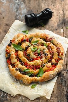 a pizza sitting on top of a wooden cutting board