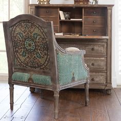 an old chair sitting in front of a desk with a book shelf on top of it