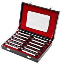 an open box with eight pieces of silverware in it