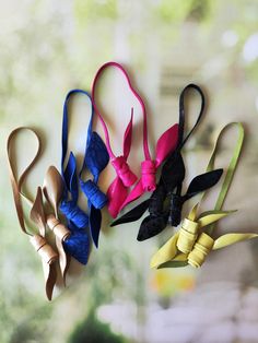 several different types of hair bows hanging on a wall