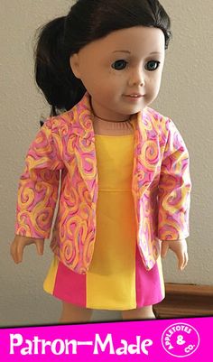 an american girl doll wearing a yellow and pink dress with a jacket over her shoulders