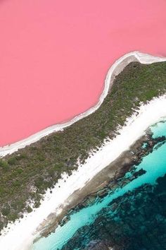 an aerial view of the water and land near pink lake in australia's outback