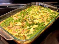 a casserole dish with broccoli and chicken in it on the stove