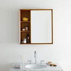 a bathroom sink with a medicine cabinet above it