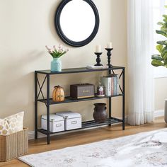 a living room with a round mirror on the wall next to a shelf filled with books