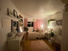 a bedroom with a bed, desk and window