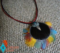 Beautiful necklace- pendant has been made from coconut decorated with Macau parrot natural feathers, Javali skin and Chryzocolla stone. adjustable circumference up to 58 CM Multicolor Feather Jewelry For Festivals, Adjustable Feather Necklace As Gift, Bohemian Feather Jewelry Gift, Adjustable Feather Jewelry For Festivals, Adjustable Feather Festival Jewelry, Macau Parrot, Parrot Feather, Coloured Feathers, Unique Pendant Necklace