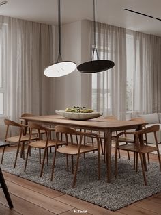 a dining room table with chairs and a bowl of fruit on it