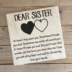 a paper sign that says dear sister with two hearts