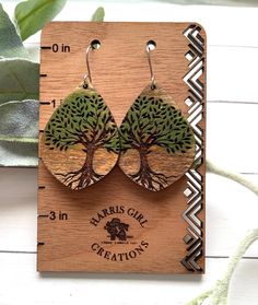 the earrings are made out of wood and have trees on them