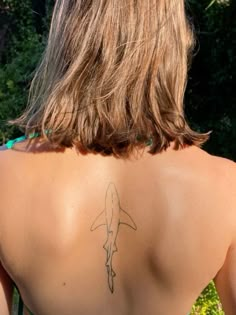 a woman with a tattoo on her back