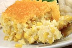 a white plate topped with mashed potatoes and corn