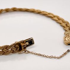 A very fine 14k gold Etruscan style bracelet.  With three delicate strands of woven braided gold wire terminating in an Etruscan style box clasp with granulated and wire work decoration.   Set with a safety chain.  Simply a finely-made Etruscan style bracelet!  Date: 20th Century  Overall Condition: It is in overall good, as-pictured, used estate condition with some very fine & light surface scratches and other signs of expected light wear consistent with age.  Fineness: Marked 14k for gold fine Elegant Braided Bracelet Jewelry, Heirloom Gold Jewelry With Box Clasp, Elegant Gold Braided Jewelry, Heirloom Style Yellow Gold Jewelry With Box Clasp, Classic Braided Jewelry For Formal Occasions, Vintage Gold Braided Bracelets As Gift, Adjustable Braided Yellow Gold Jewelry, Elegant Braided Bracelets For Formal Occasions, Elegant Yellow Gold Bracelet With Wheat Chain