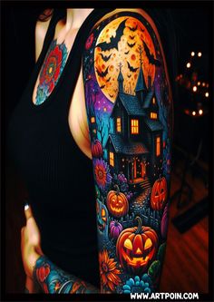 a woman with tattoos on her arms and arm is wearing a black tank top that has an image of a house in the background