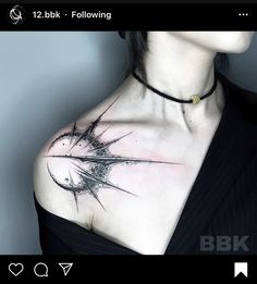 a woman's chest is covered in black ink and has an arrow tattoo on it