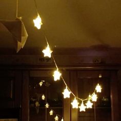 some white stars are hanging from the ceiling