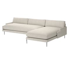 a white sectional couch with black legs