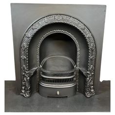 an ornately carved fireplace with a black hearth