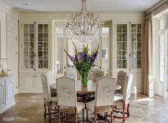 a dining room table with chairs and a chandelier