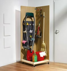 a room with a coat rack and brooms on the floor next to a door