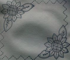 a close up of a piece of cloth with flowers on it and lines in the background